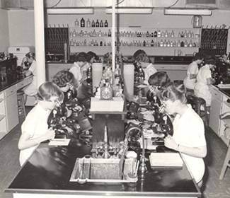 historic photo of young students in a lab environment