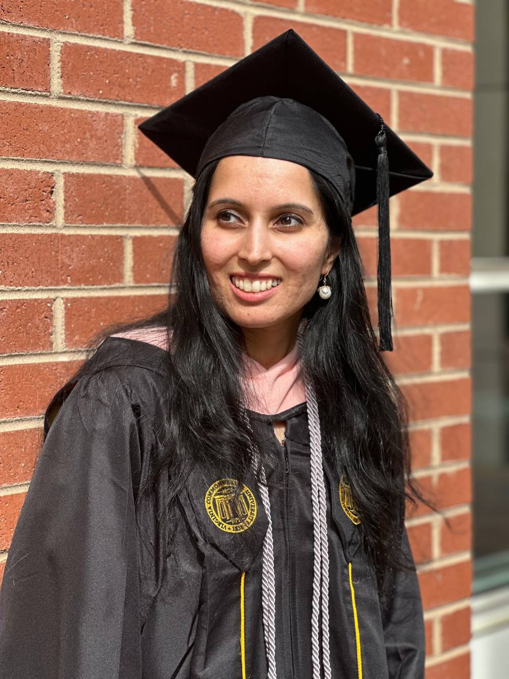 Poonamdeep Bajwa in graduation cap and gown